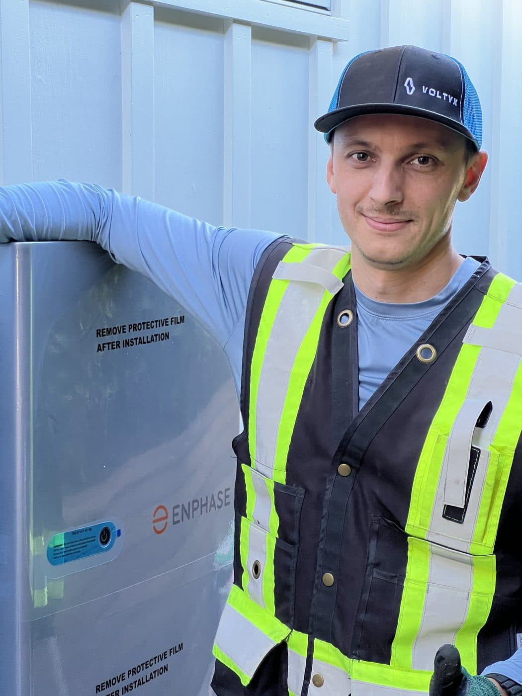 Tim beside a newly installed Enphase battery